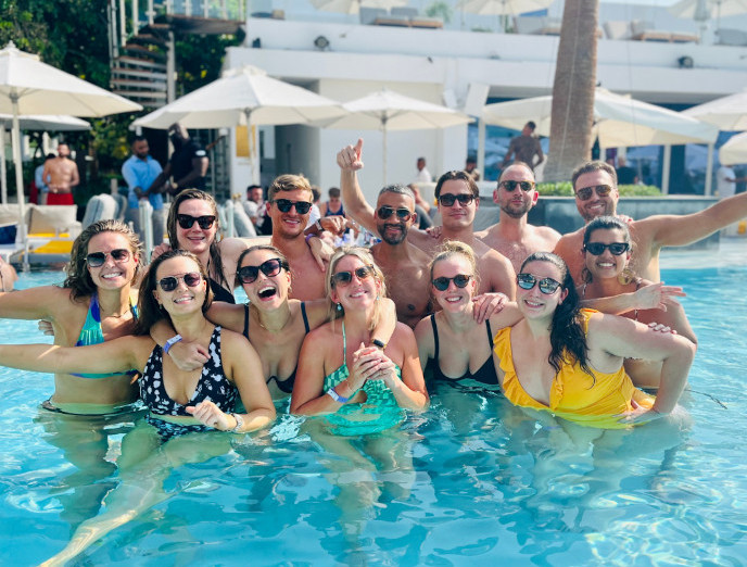 a group of people standing in a swimming pool.