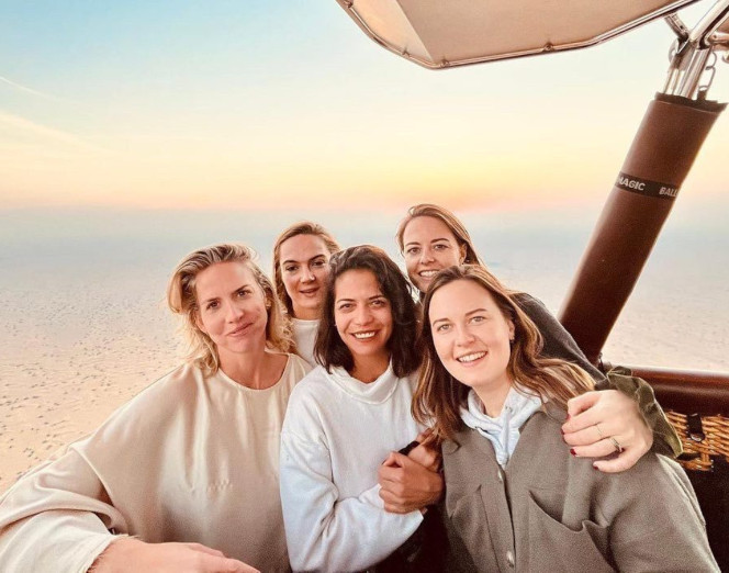 a group of people standing in a hot air balloon.